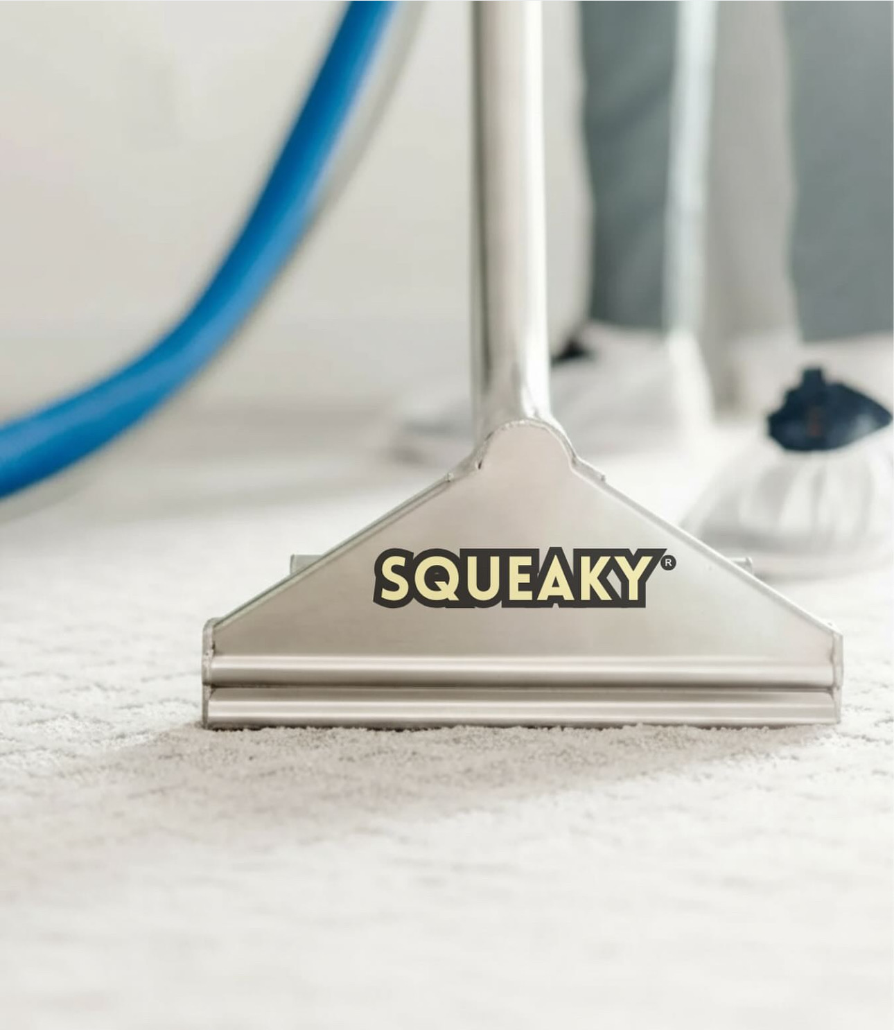 Squeaky extraction wand cleaning a light-colored residential carpet